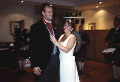 Sarah and Neil stand to receive the band